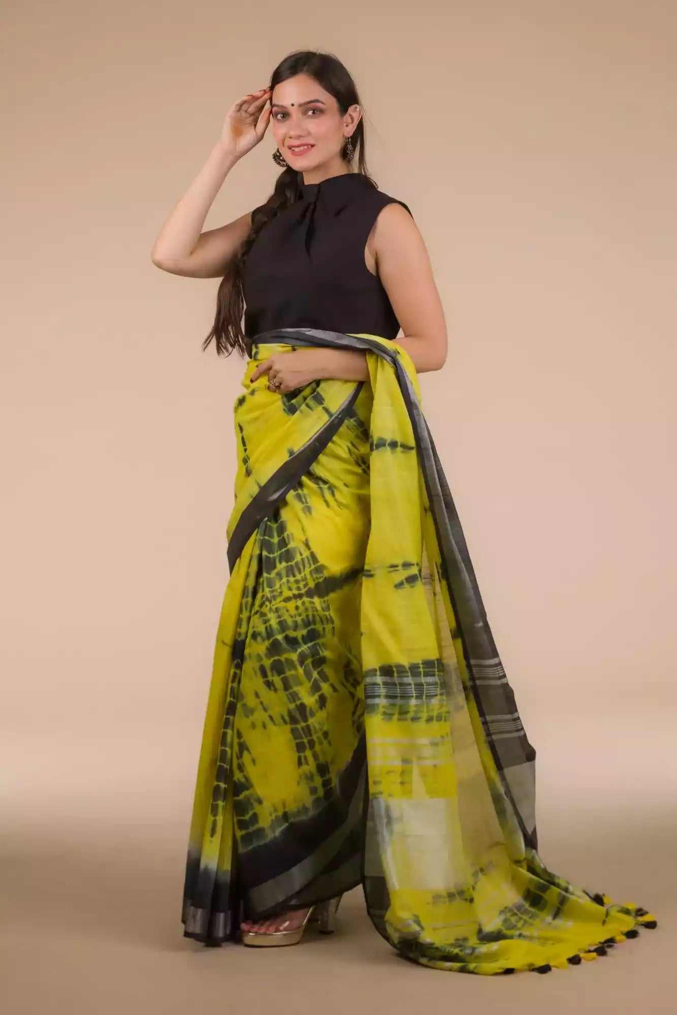 a beautiful woman with long hairs wearing a multicolor saree with black blouse, flaunting the flowy loose end of her saree 