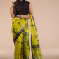 front view of a beautiful woman with long hairs wearing a multicolor saree with black blouse and a flowing pallu