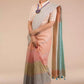 a beautiful woman with a bun wearing a multicolor pastel saree with multicolor blouse and minimum jewellery