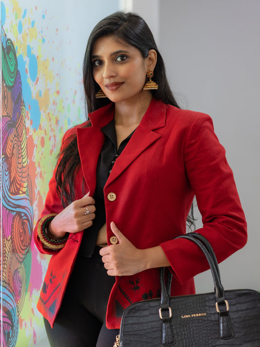 A gorgeous picture of lady in Stylish Maroon Blazer with Warli Art womens workwear holding a bag